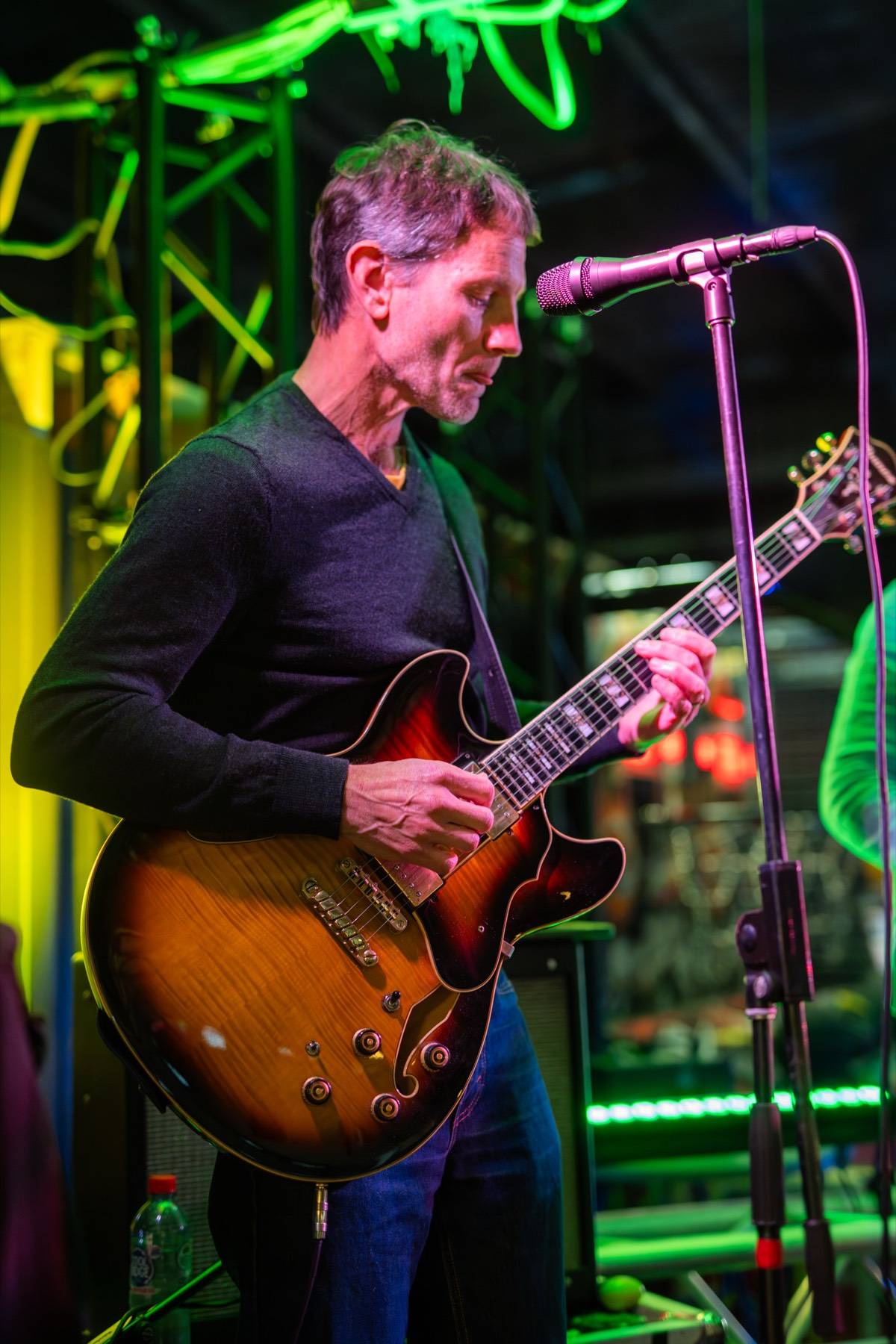 Calvin Raison playing guitar on stage at the Devonport Jazz Festival, 2024
