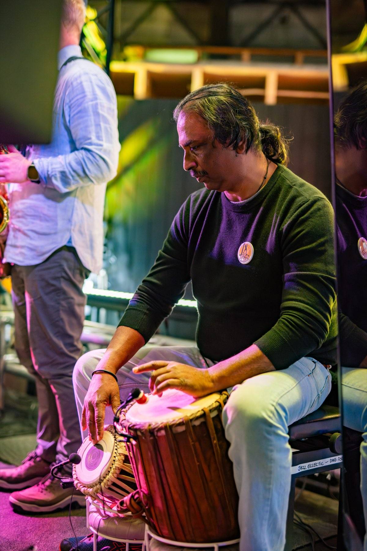 Dave Fernandez playing tablas on stage at the Devonport Jazz Festival, 2024