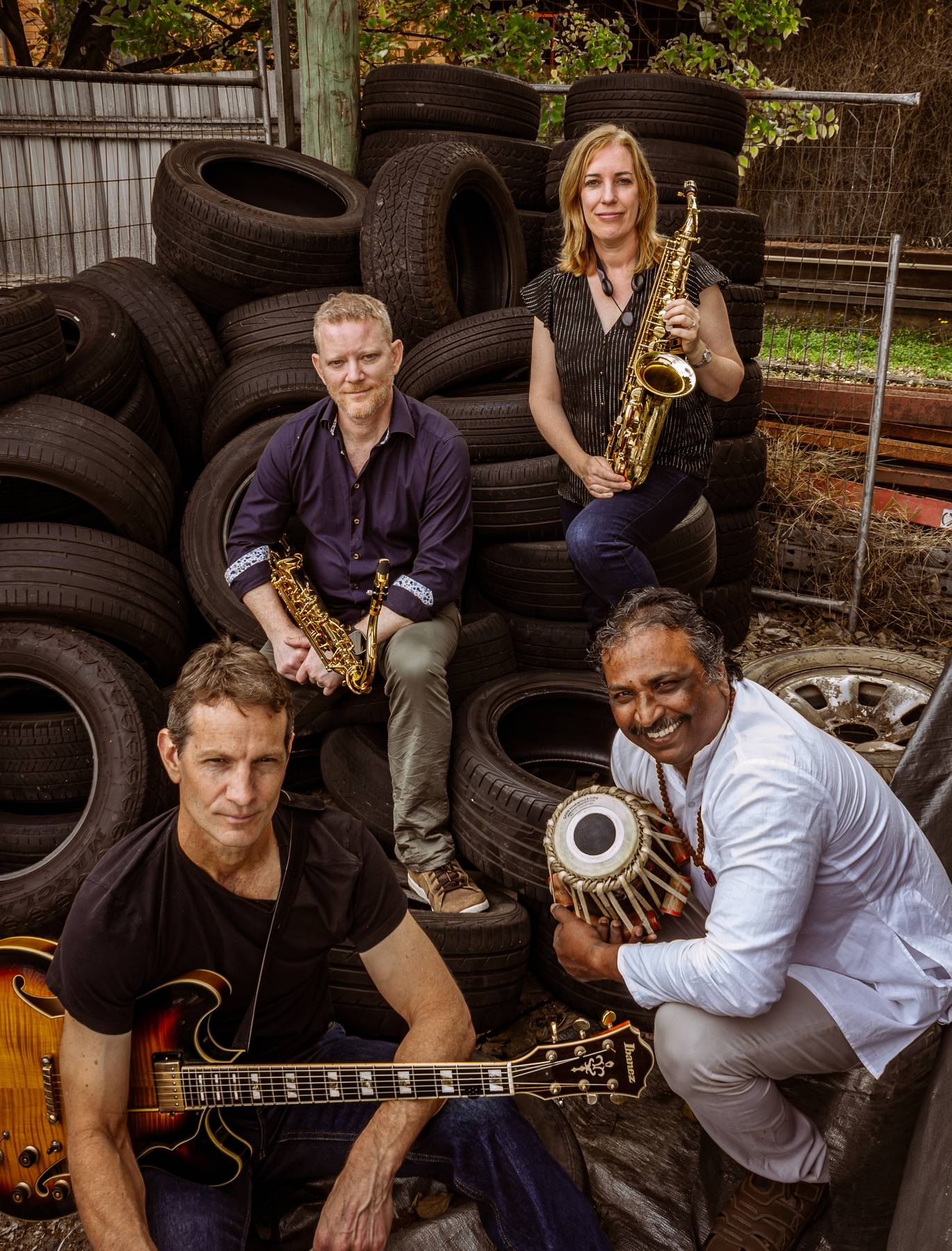 Jazz Eclectic band portrait among stacked tyres — Trent Jordan, Katrina Fawns, Calvin Raison and Dave Fernandez