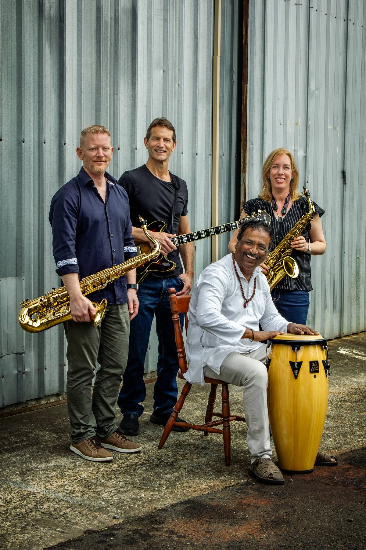 Jazz Eclectic band portrait — Dave Fernandez seated at the drum with Trent Jordan, Calvin Raison and Katrina Fawns standing